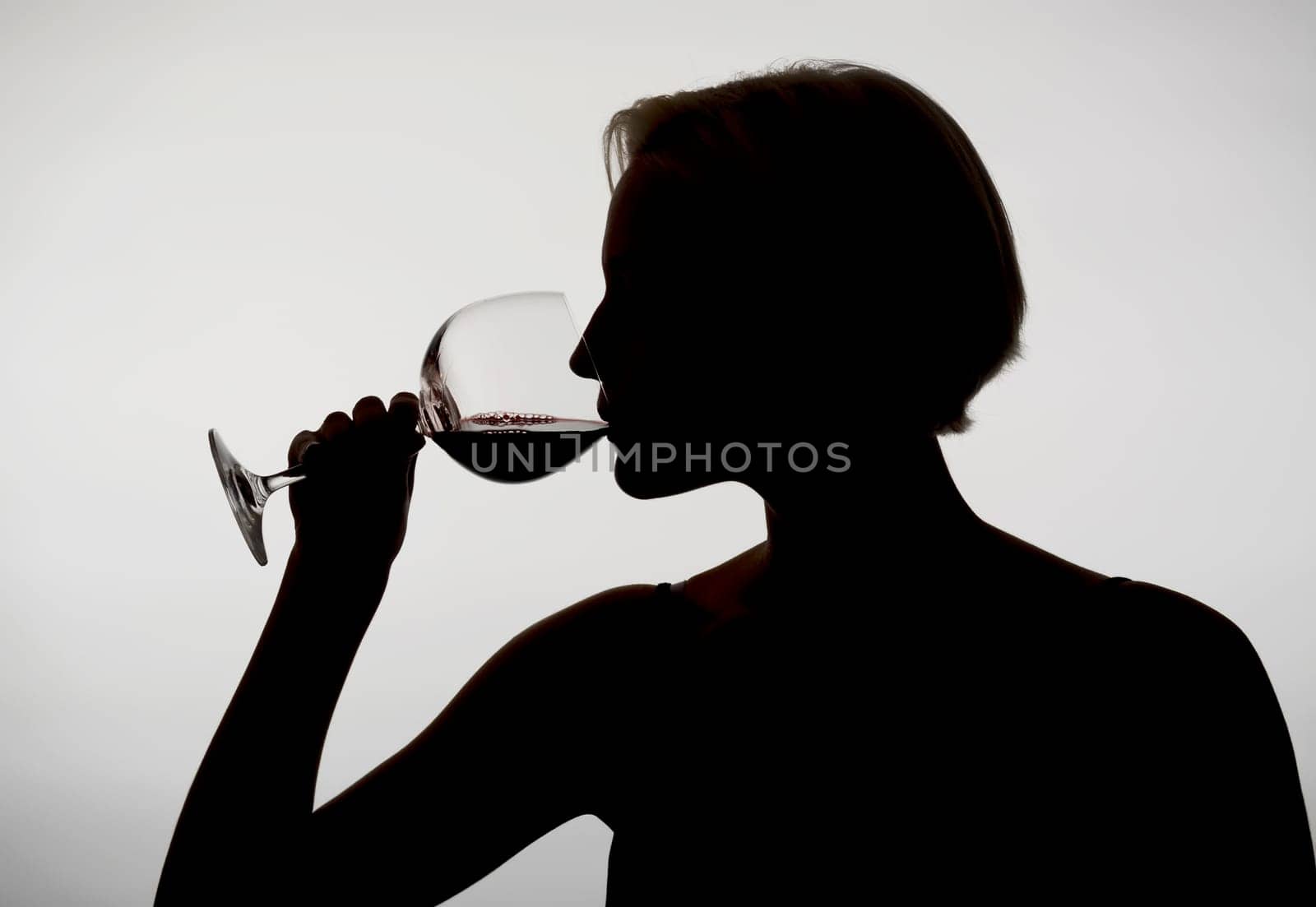 Woman drinks red wine
