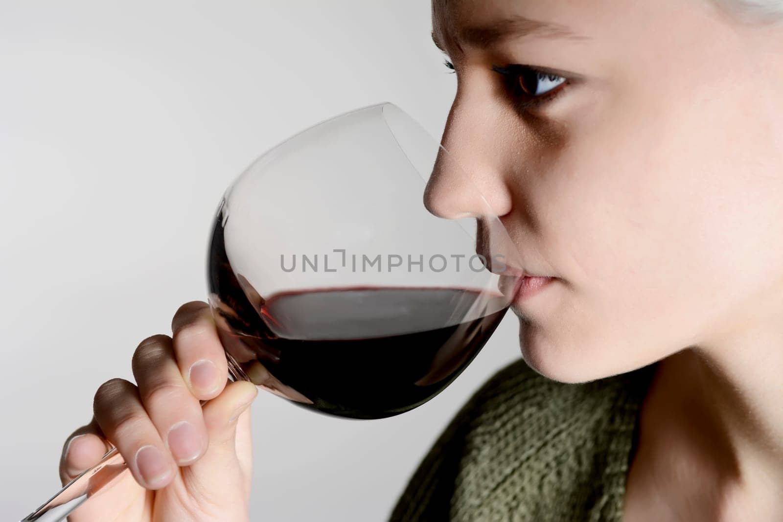 Woman drinks red wine