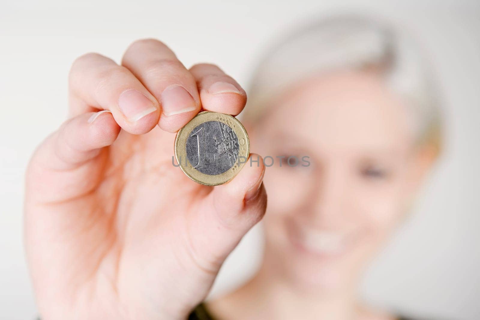 Woman holds one euro