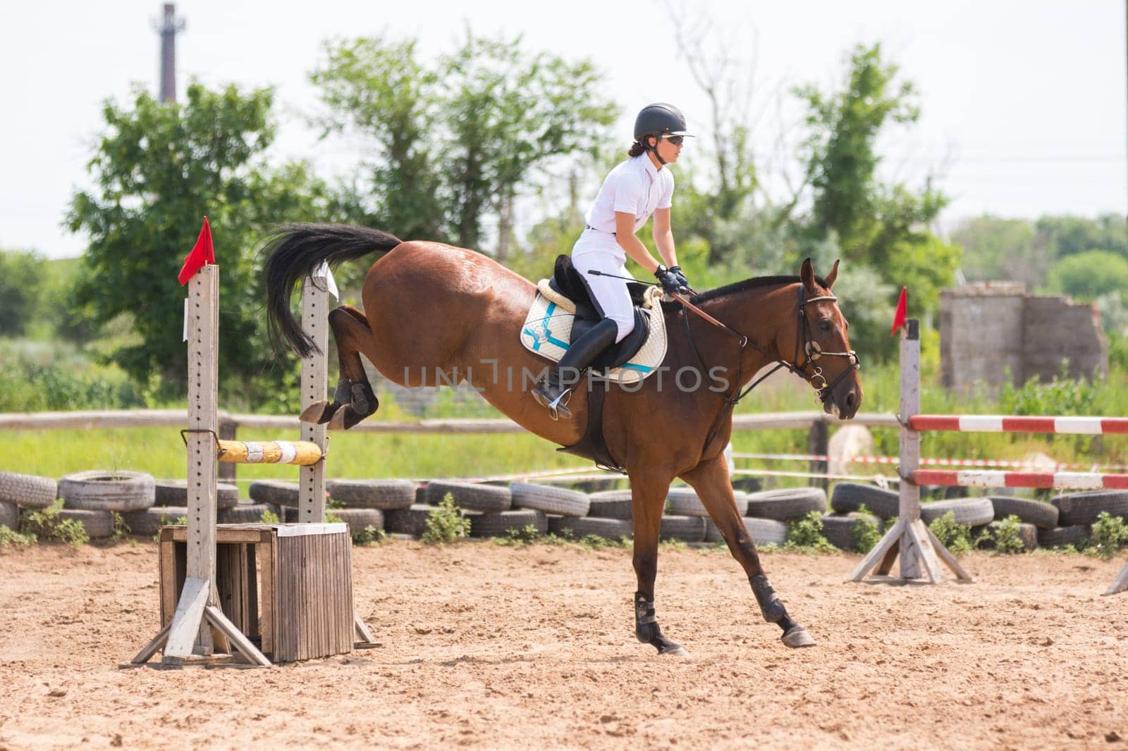 Volgograd, Russia - June 19, 2016: The moment of landing a horse with rider after the jump through the barrier
