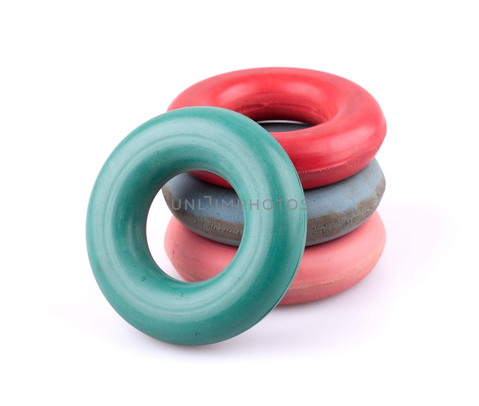 Four rubber hand rings trainers for exercise on white background.