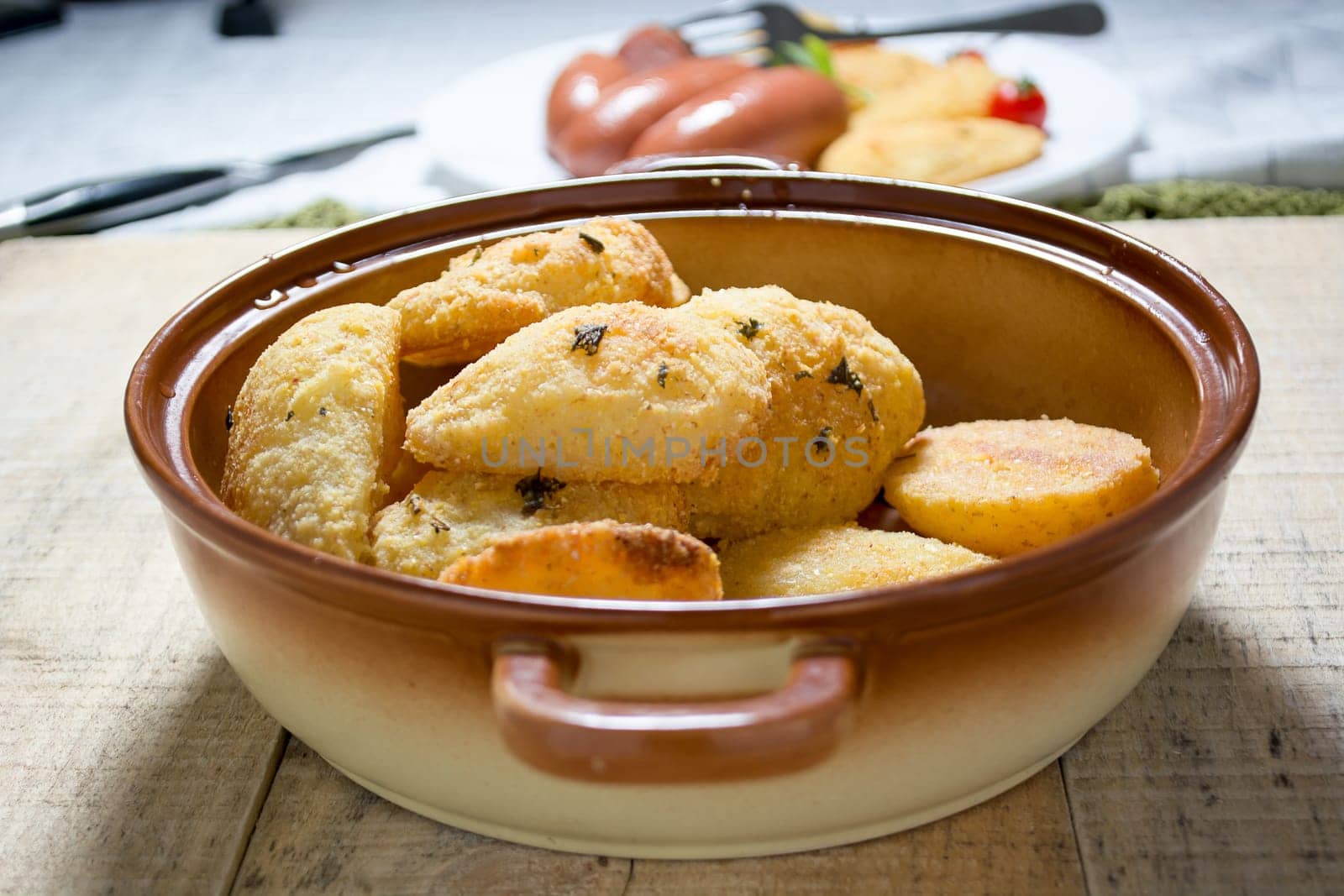Breaded potato fried in the dish. Blurred background