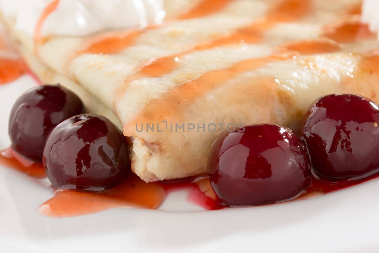 Fresh pancakes with cherry arranged on wooden table