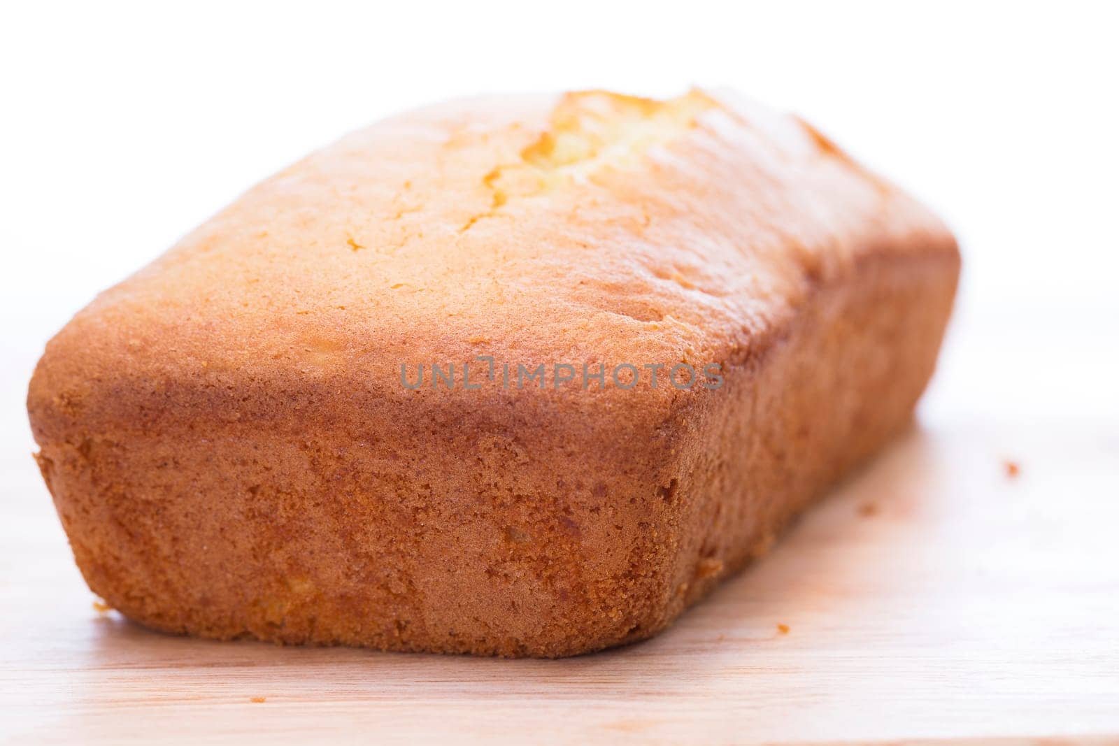 Lemon pound cake loaf uncut on cutting board.