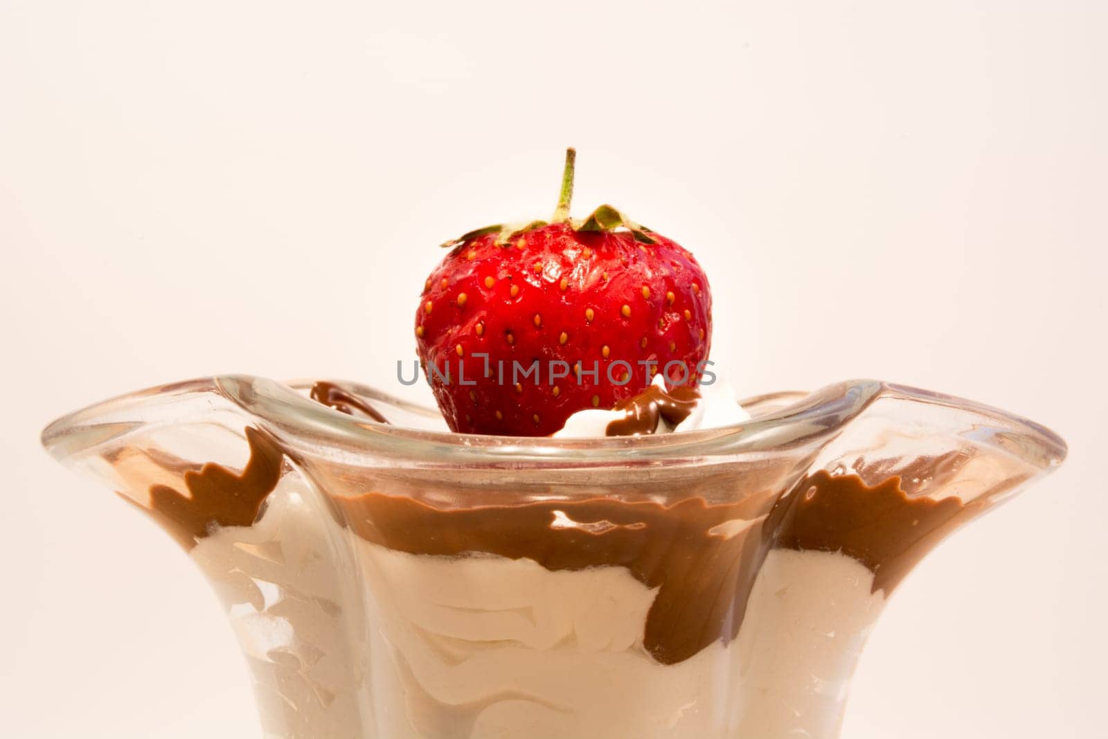 Glass cup with mixed vanilla and chocolate with strawberry