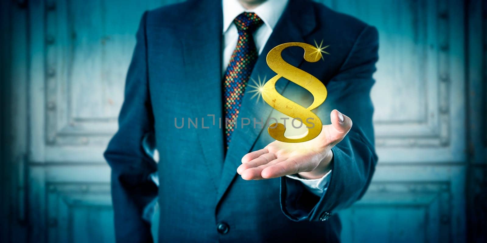 Male corporate attorney offering a golden section sign hovering above his open palm of hand. Business concept for justice system, legal representation, court proceedings, compliance and consultancy.