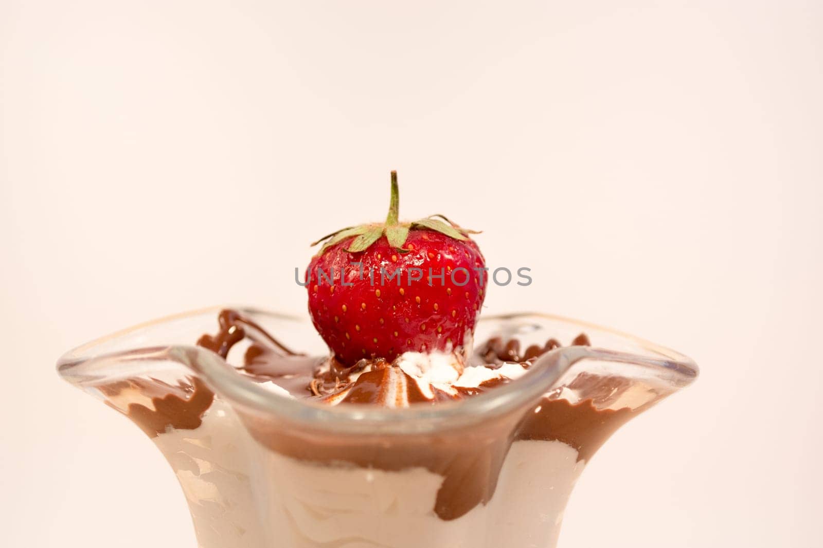 Glass cup with mixed vanilla and chocolate with strawberry
