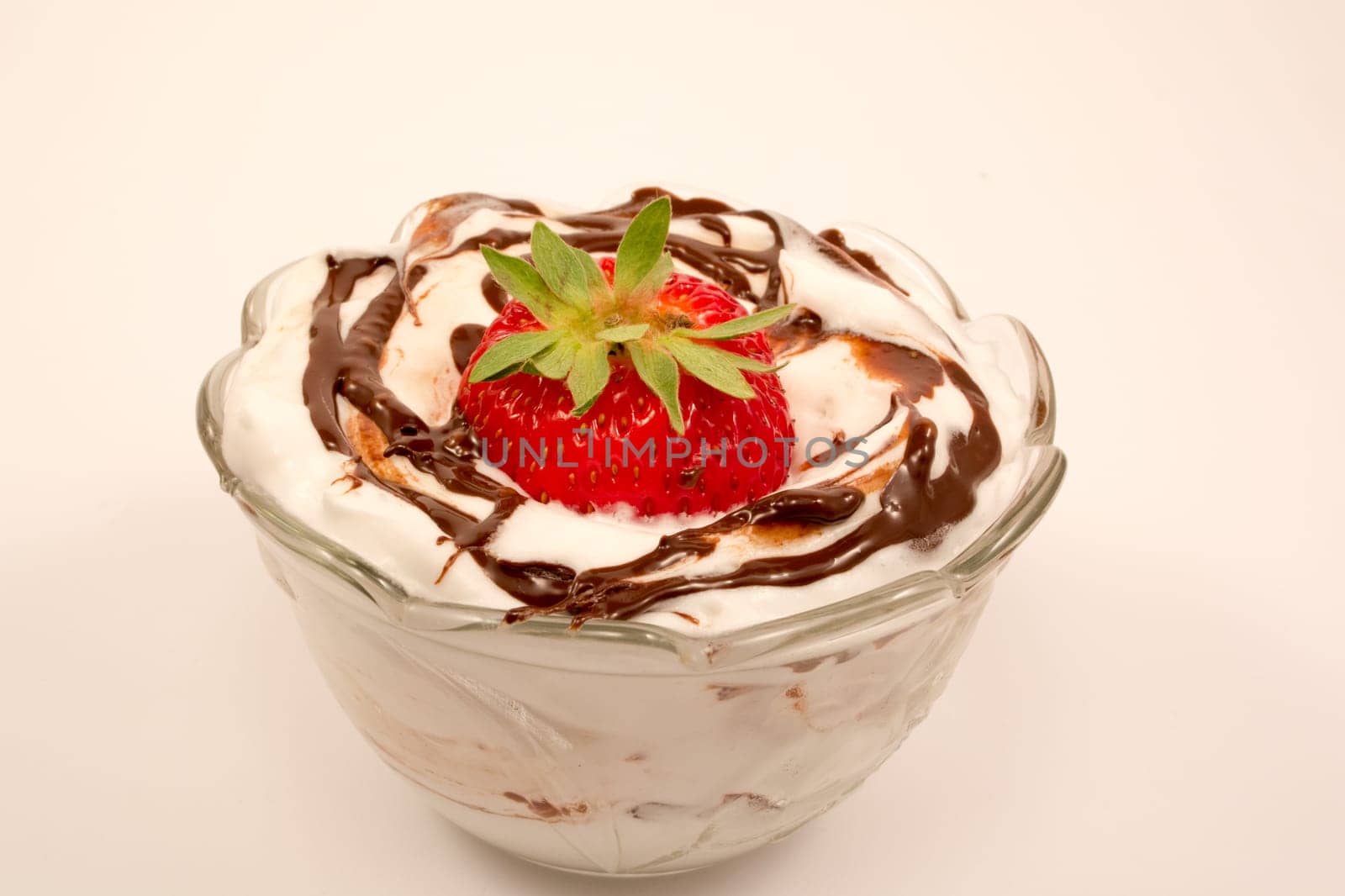 Strawberry on tof of creamy desert with vanilla and chocolate