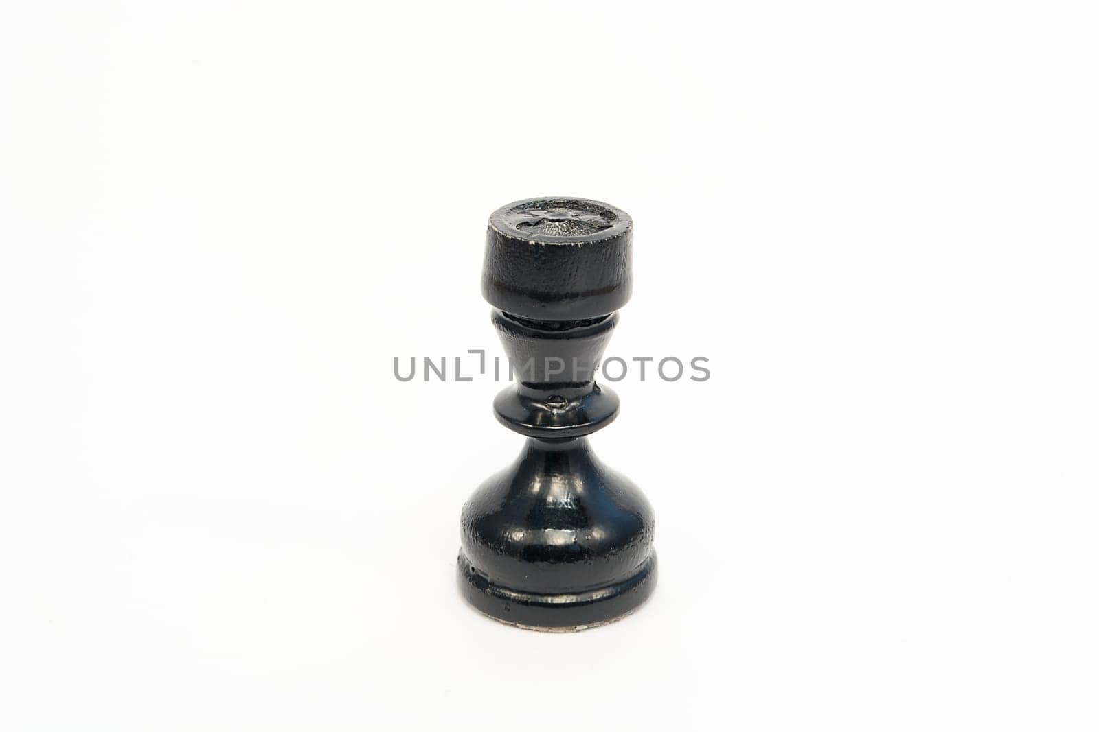 Old wooden chess piece black rook isolated on white background
