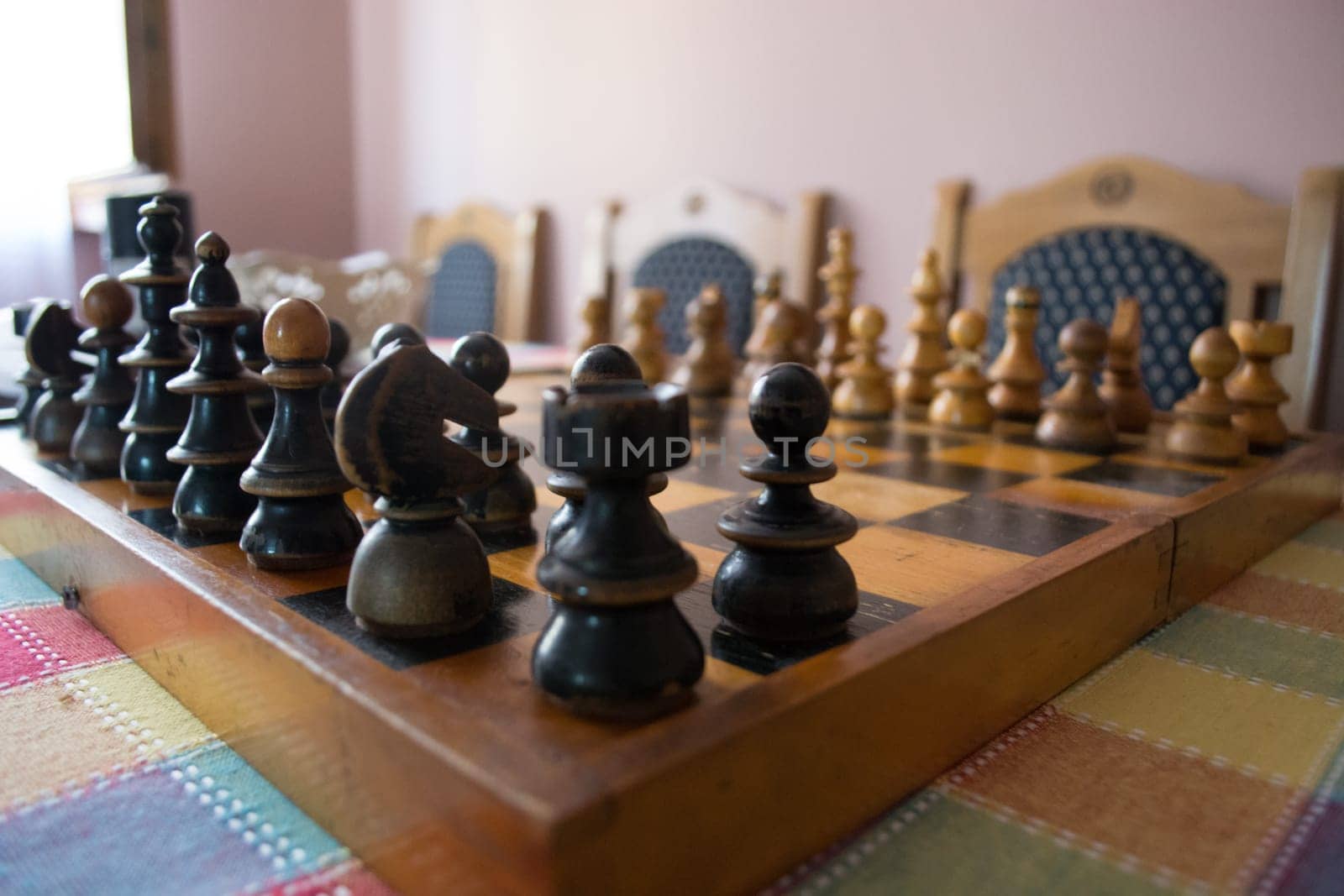 Chess table in the living room with chess pieces lined up