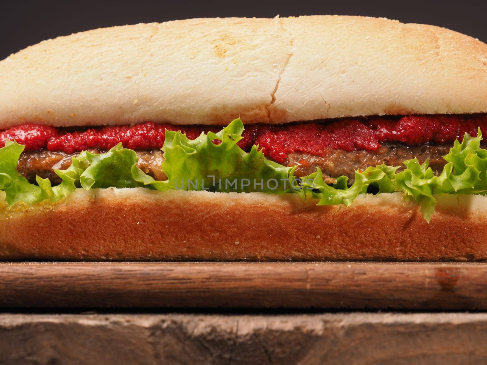 Closeup shot of a delicious burger on a rustic wooden table