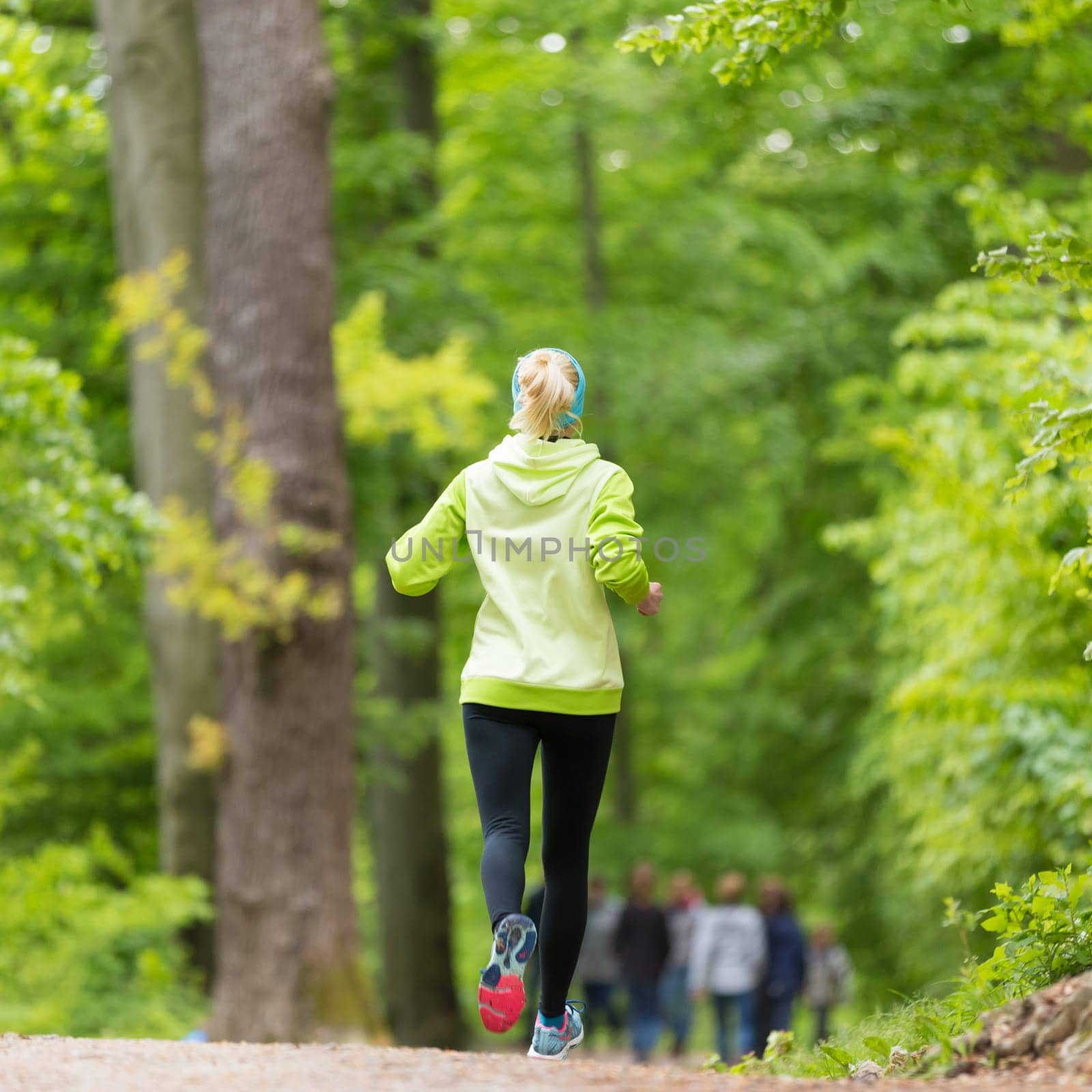 Sporty young female runner in forest.  Running woman. Female runner during outdoor workout in nature. Fitness model outdoors. Weight Loss. Healthy lifestyle.
