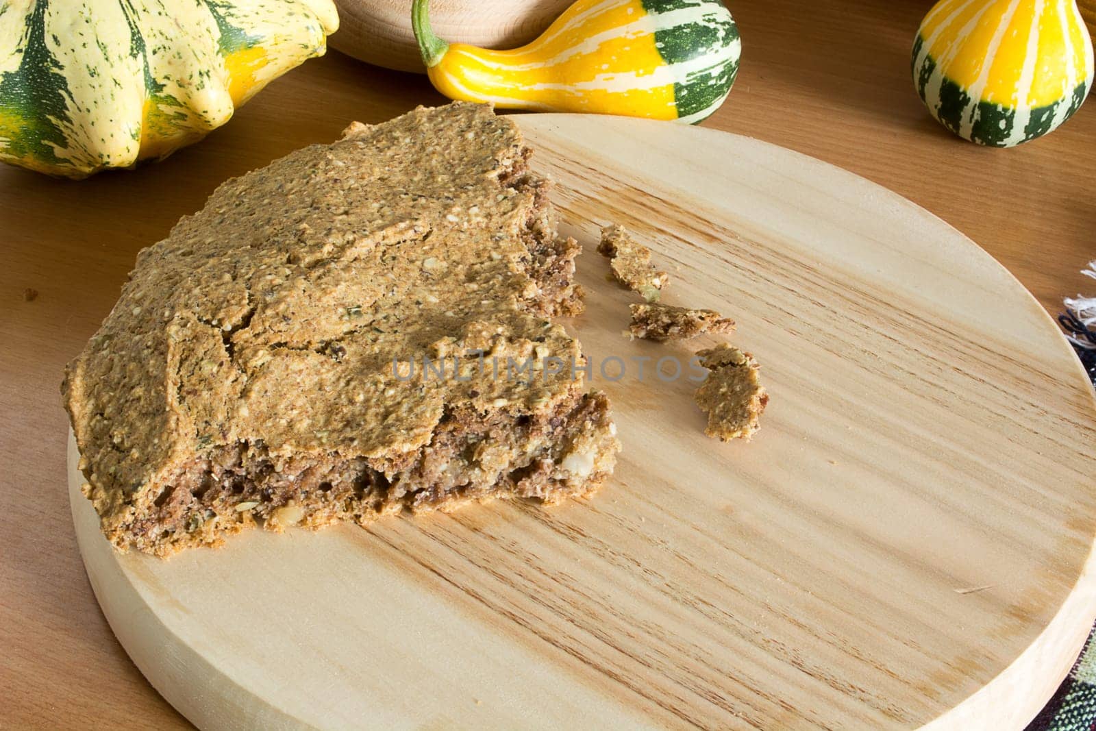 Part of just baked, fresh, domestic unleavened barley bread on the wooden plate