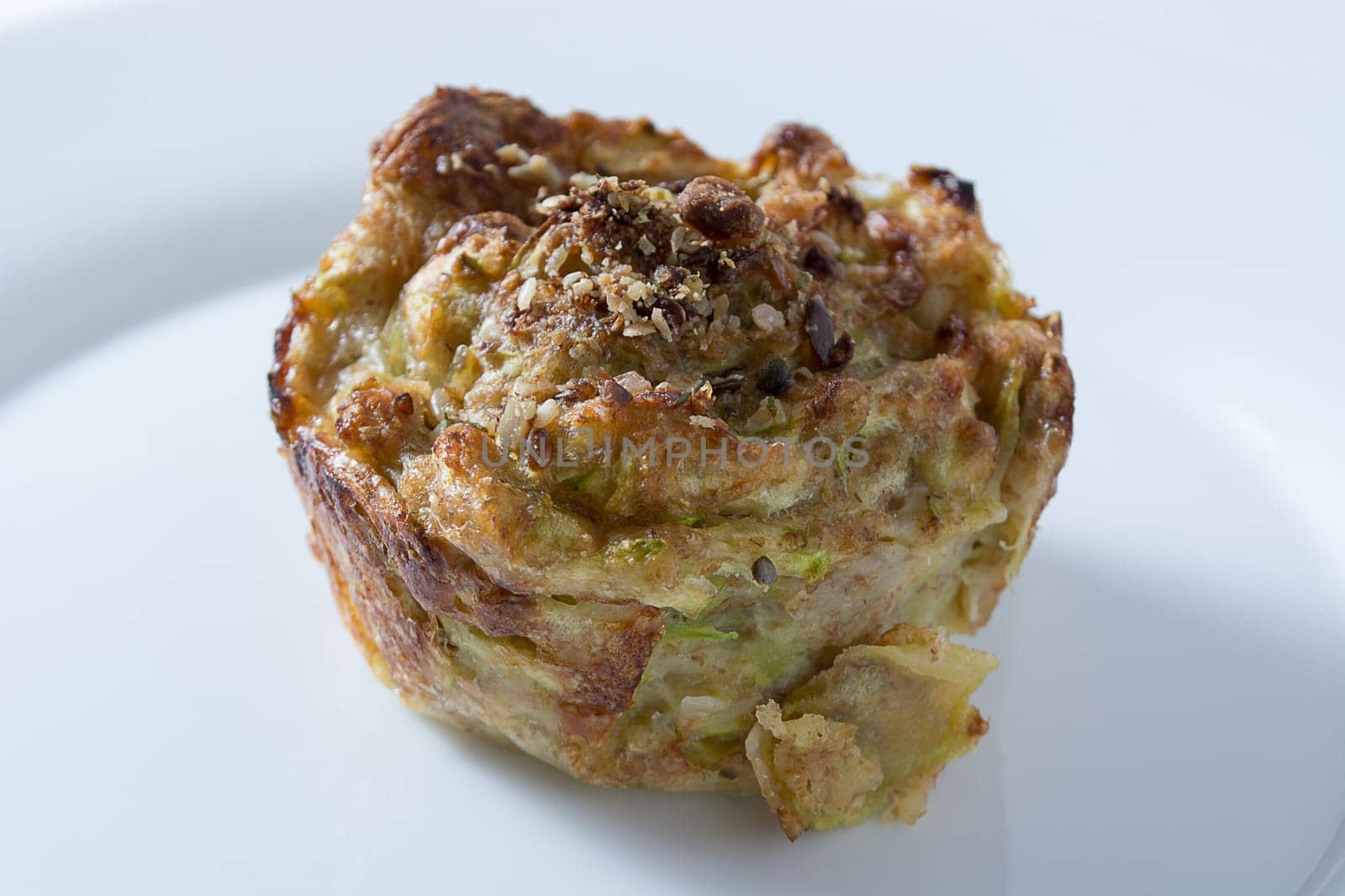 Zucchini muffins in white plate isolated on white background