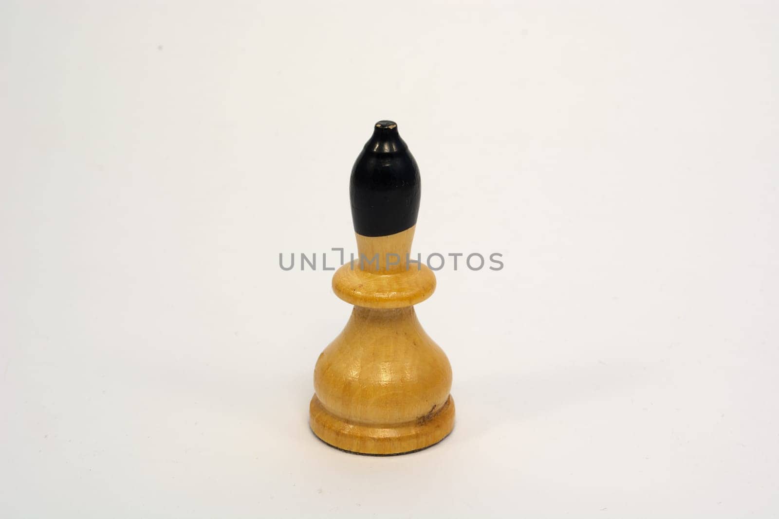 Old wooden chess piece white bishop isolated on white background