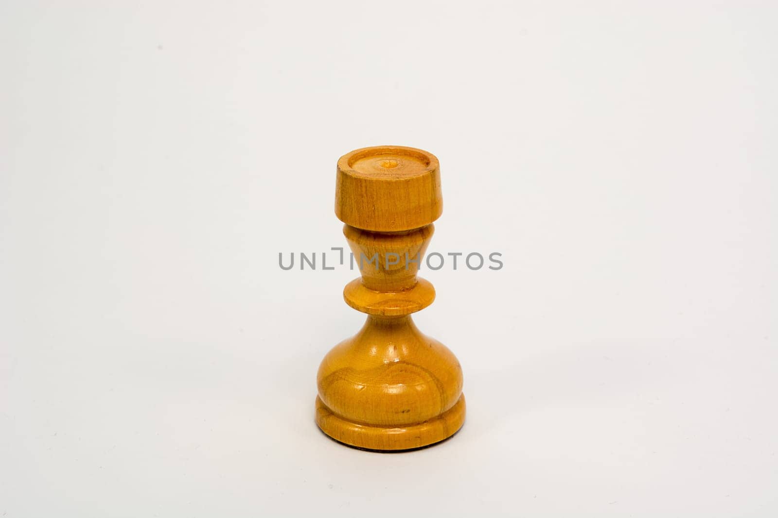 Old wooden chess piece white rook isolated on white background