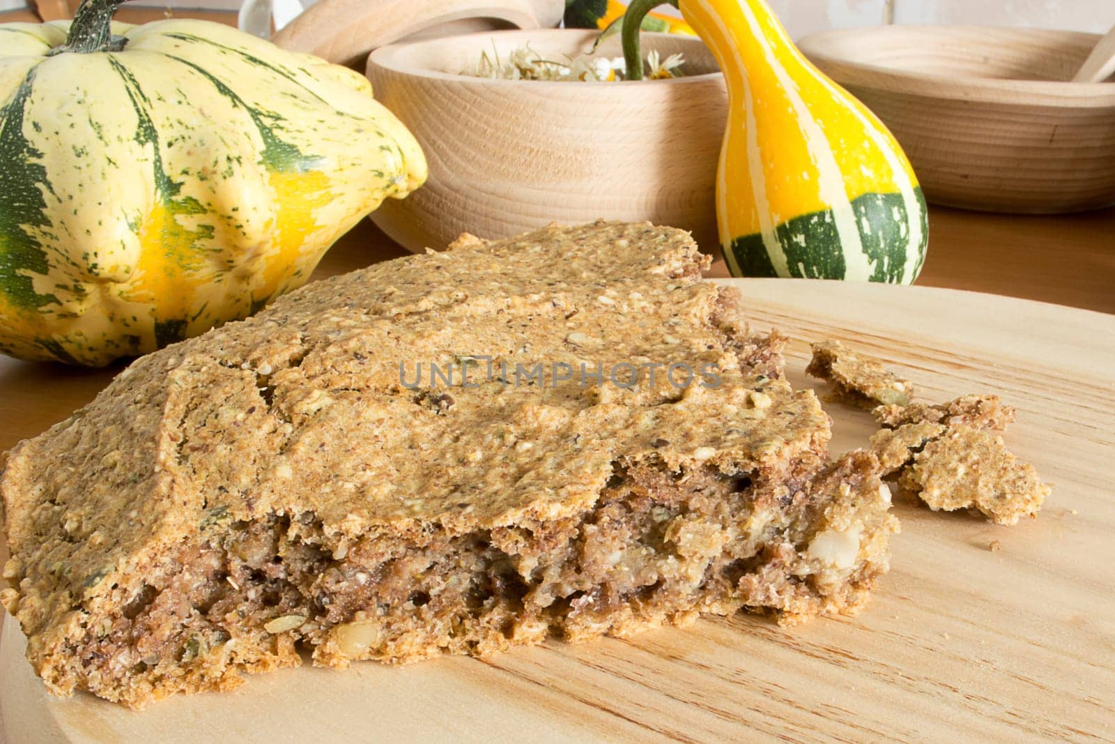 Part of just baked, fresh, domestic unleavened barley bread on the wooden plate