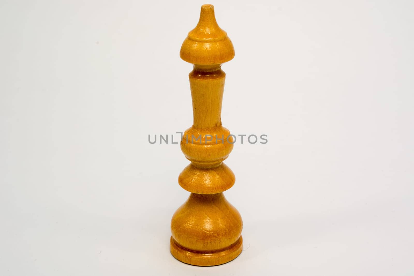 Old wooden chess piece white King isolated on white background