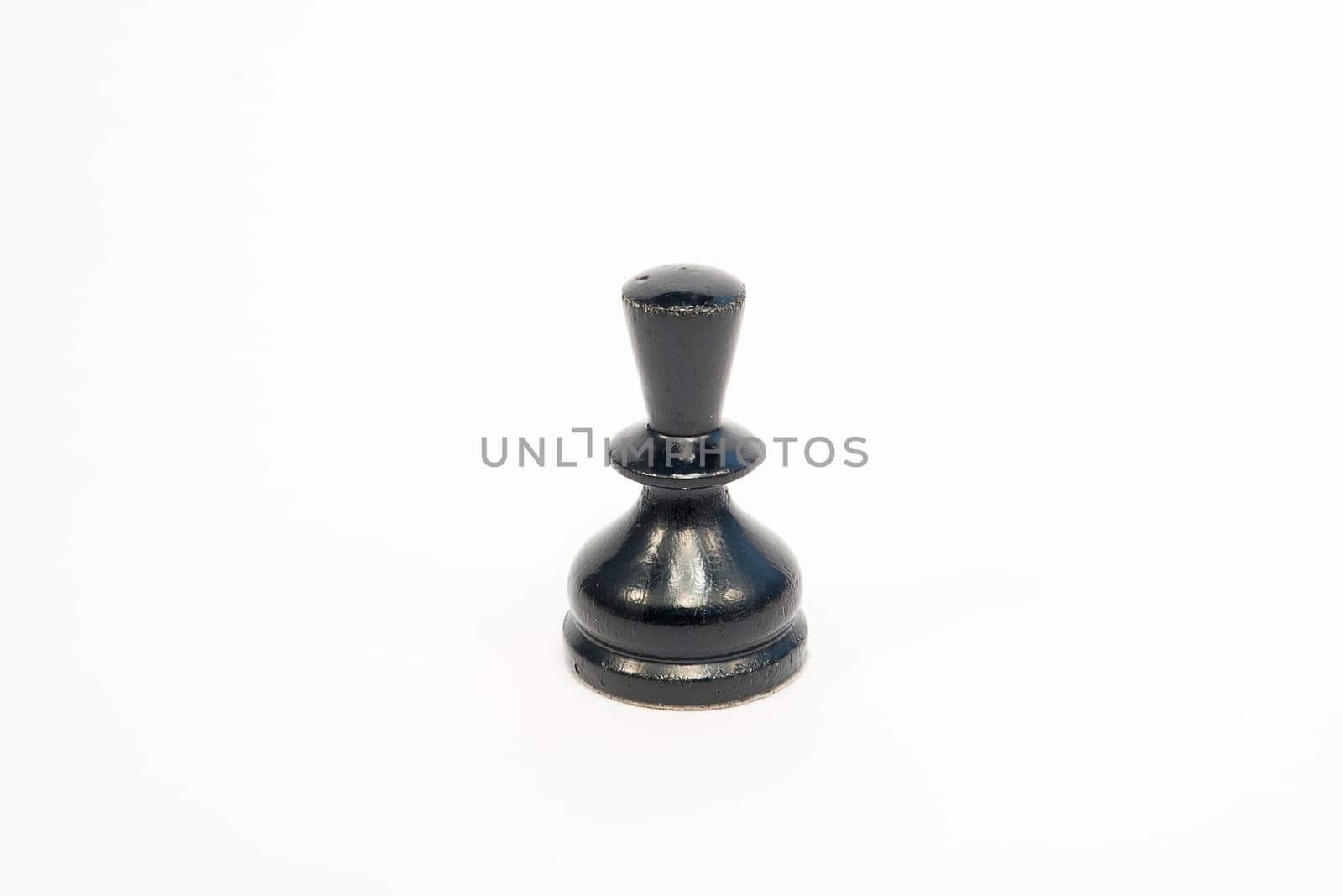 Old wooden chess piece black pawn isolated on white background