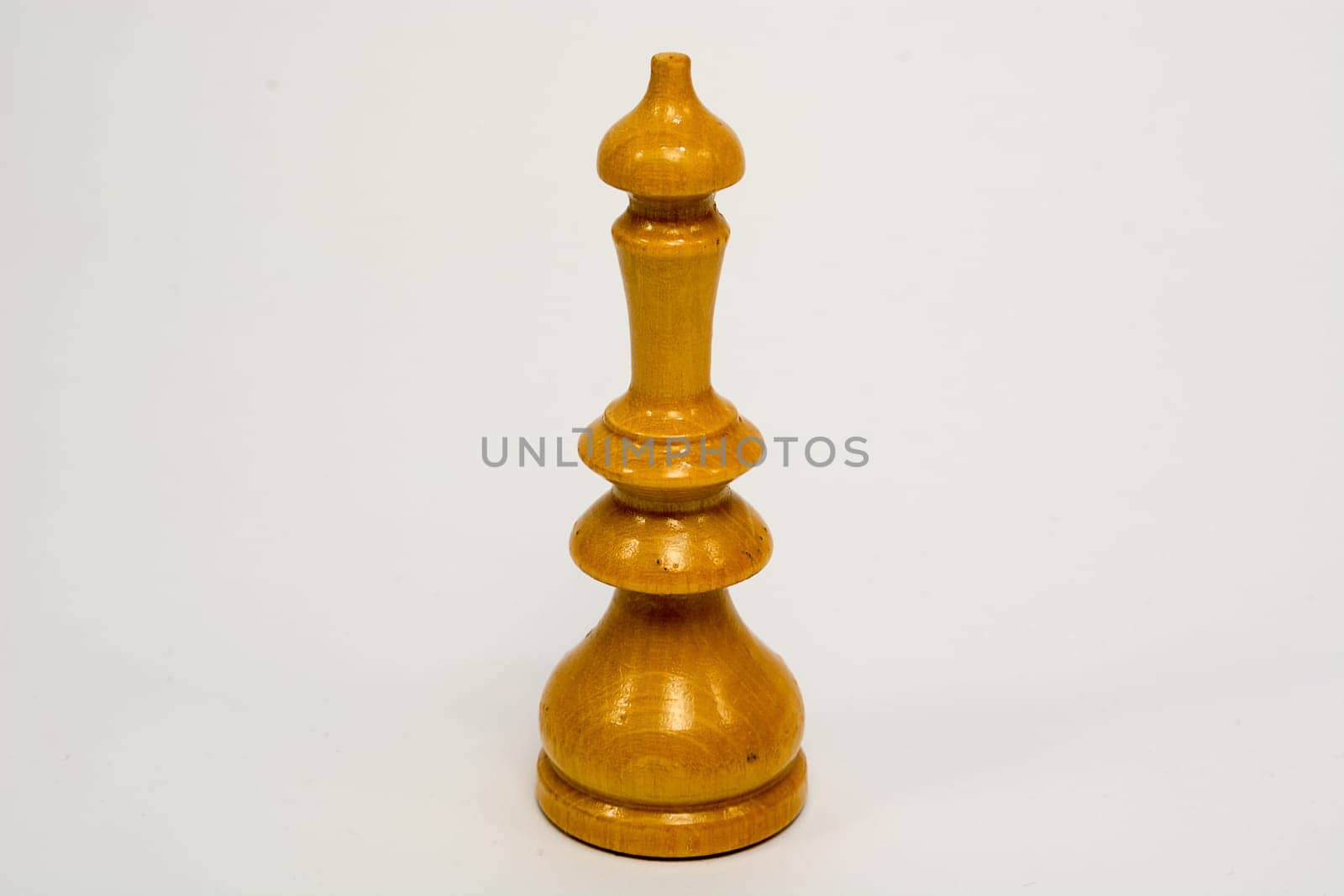 Old wooden chess piece white queen isolated on white background