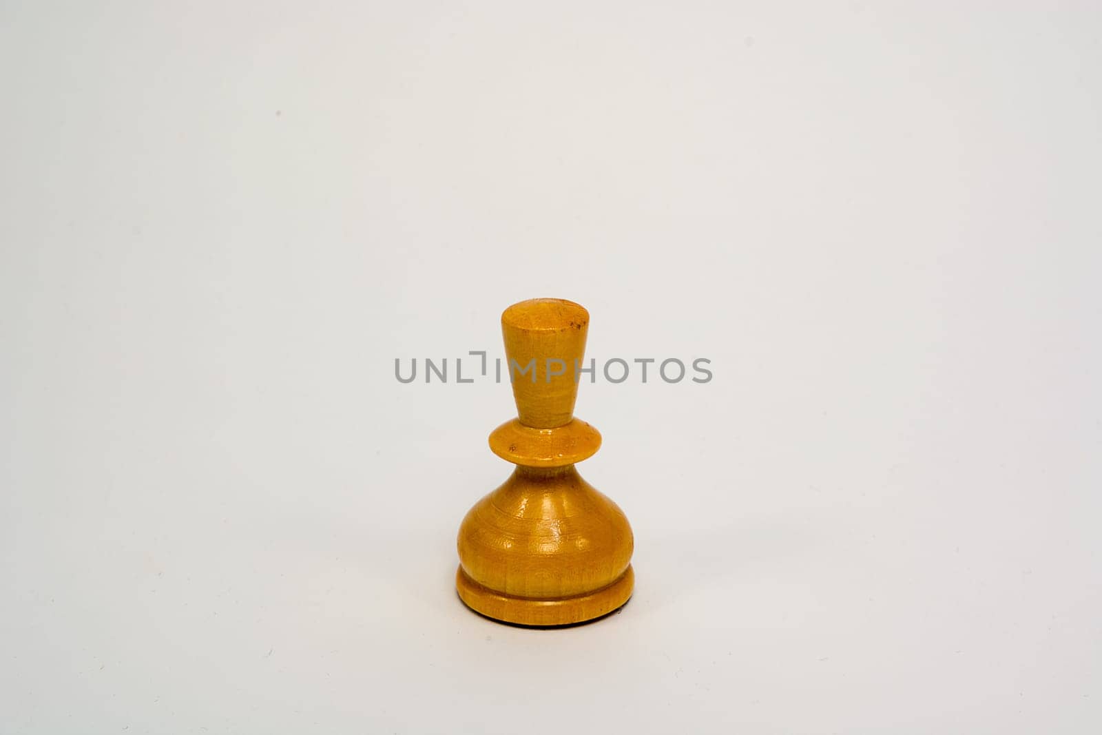 Old wooden chess piece white pawn isolated on white background