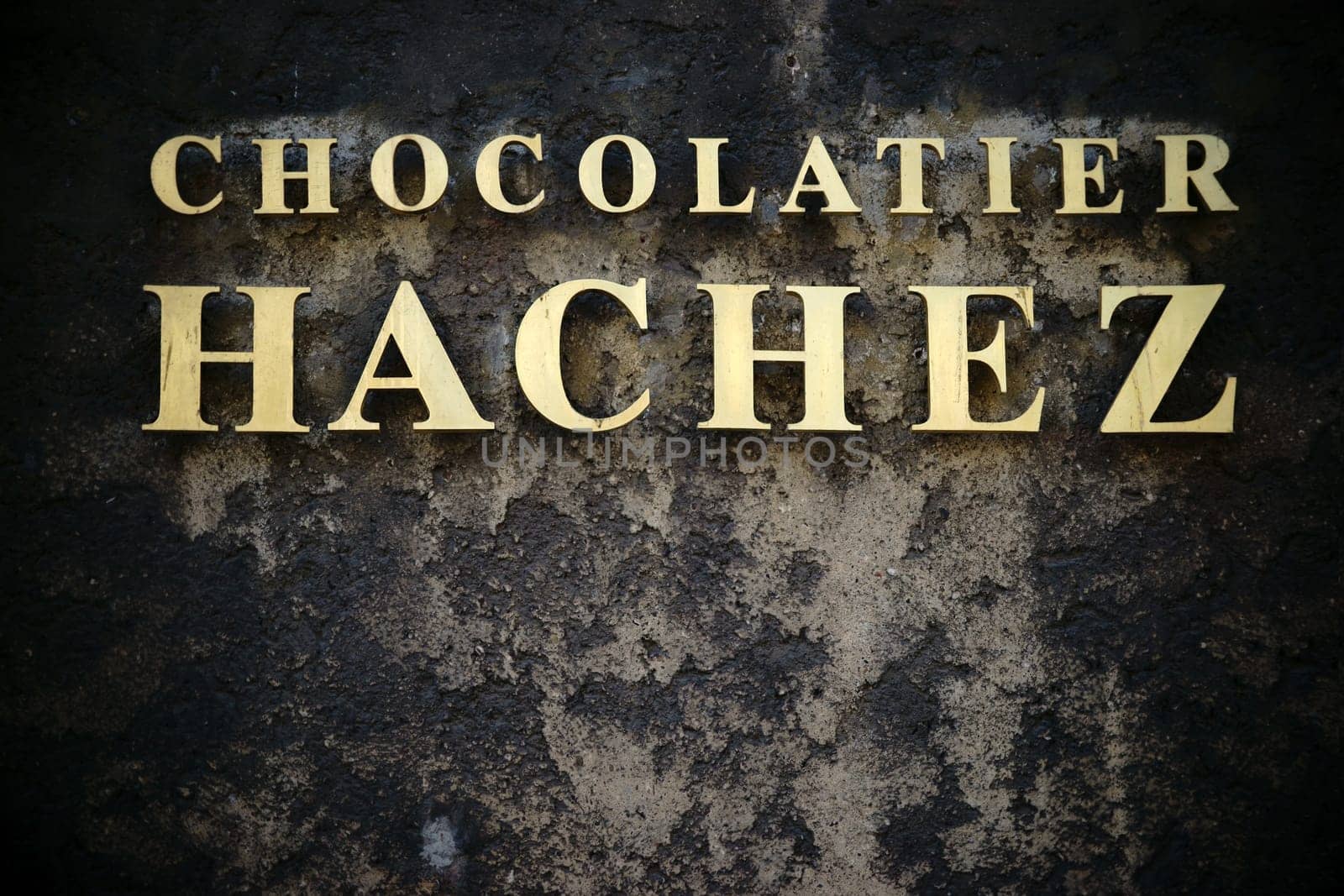 Bremen,Germany - August 30,2016: The golden name tag of the Bremen chocolate factory Hachez & Co on a soot-blackened house façade on August 30,2016 in Bremen.