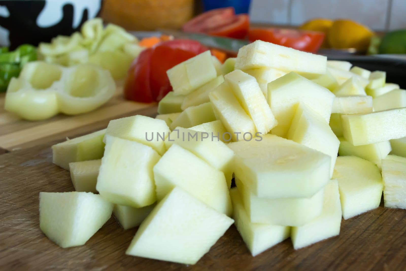 Kitchen full of various vegetables. Pepper, tomatoes sliced and ready to be boiled