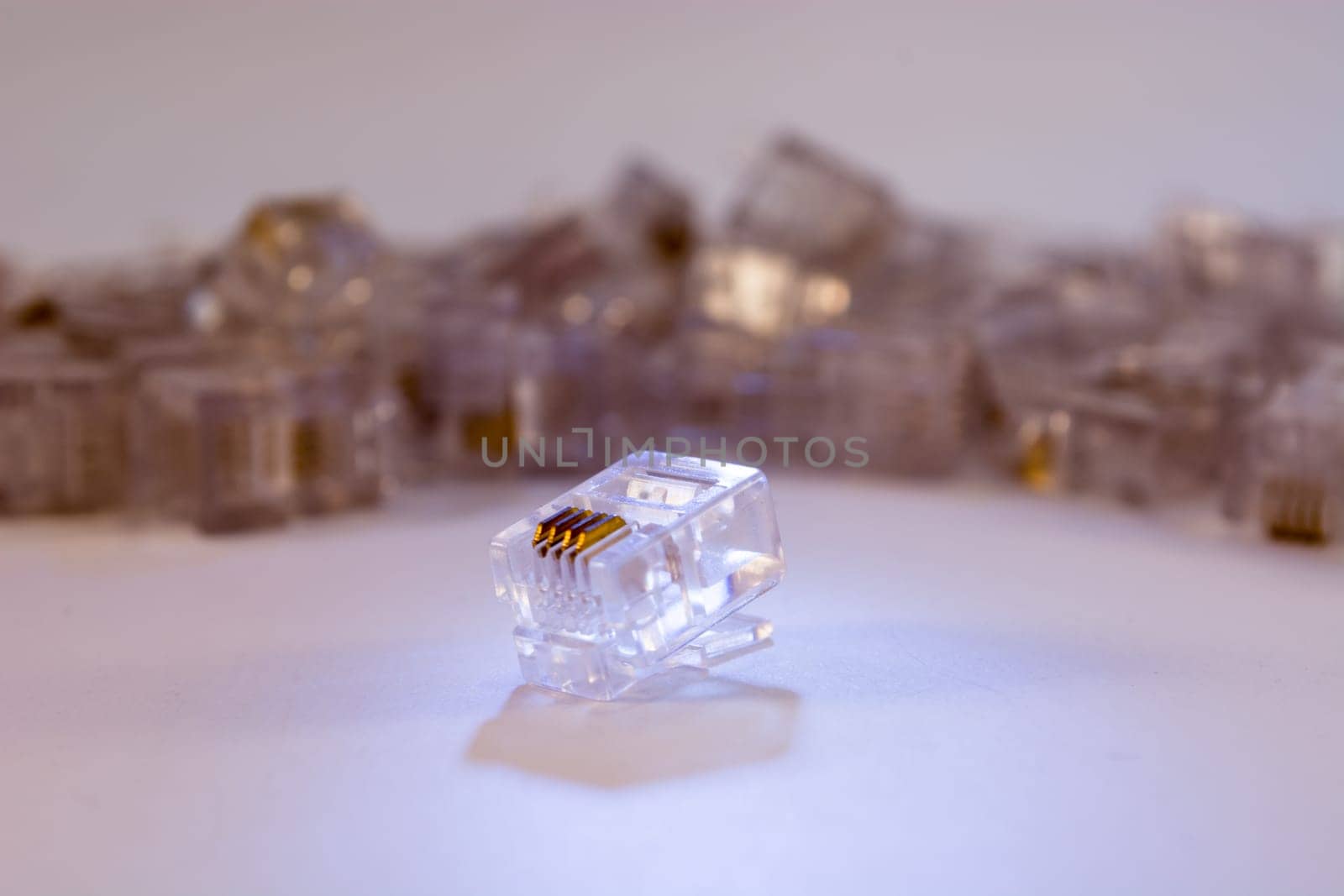 Group of RJ-45 connectors on white background, Connectors are translucent and collored with blue light