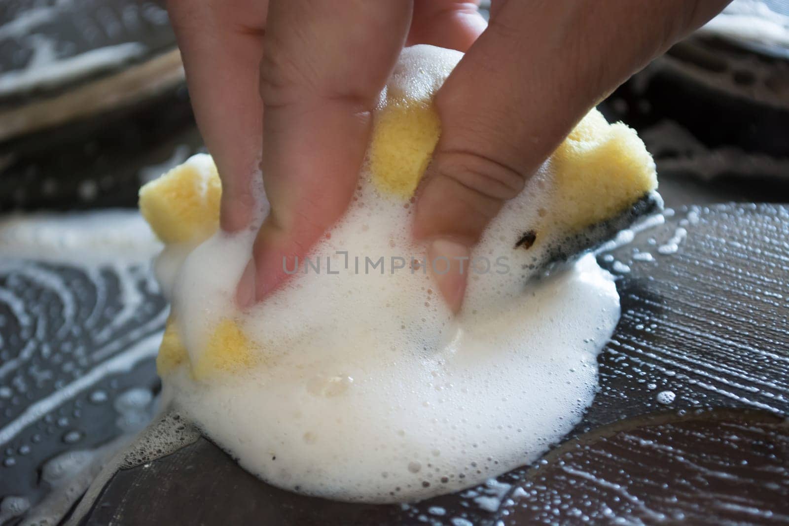 Close up of woman cleaning cooker at home kitchen