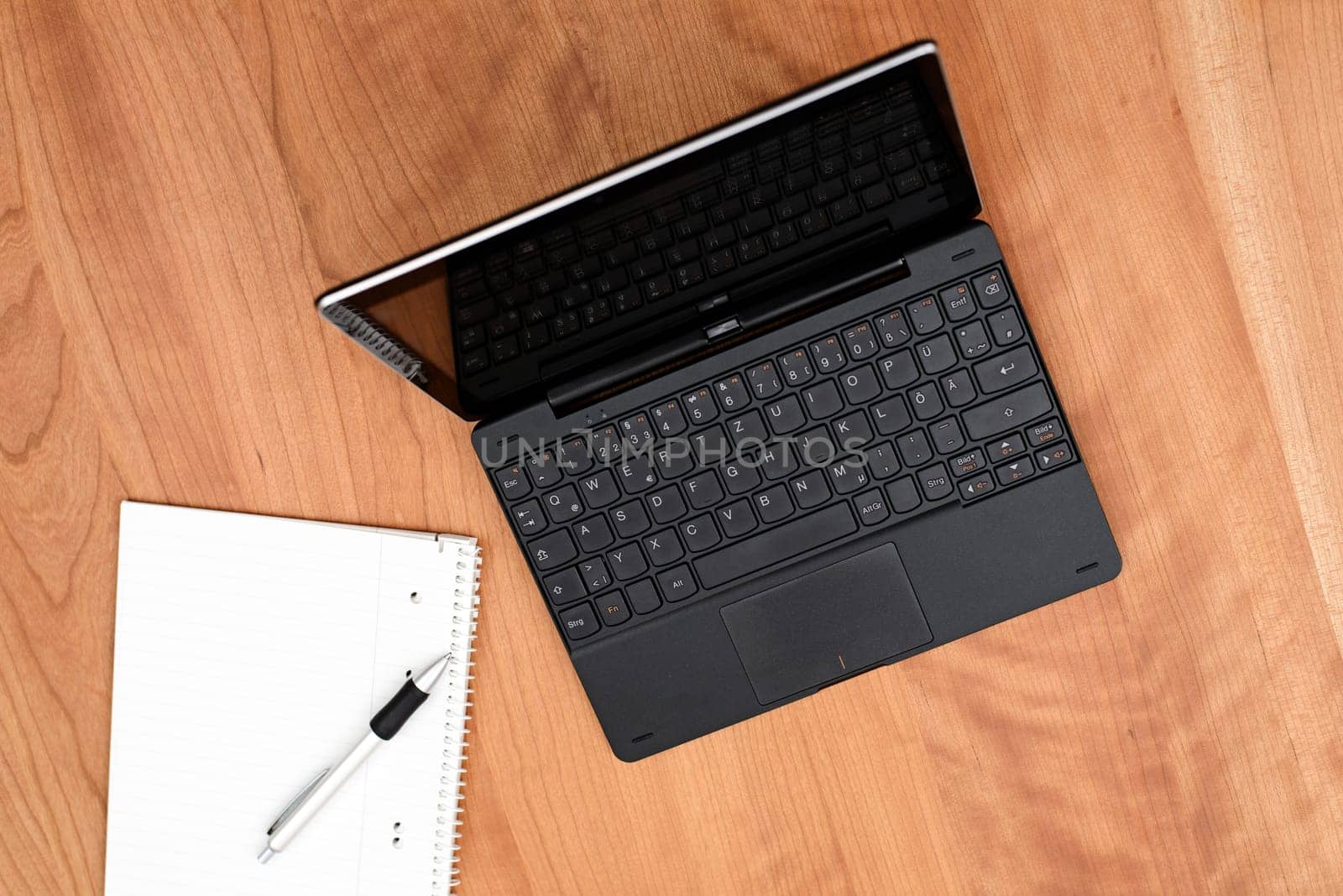 notebook and notepad with pen on wooden table from above