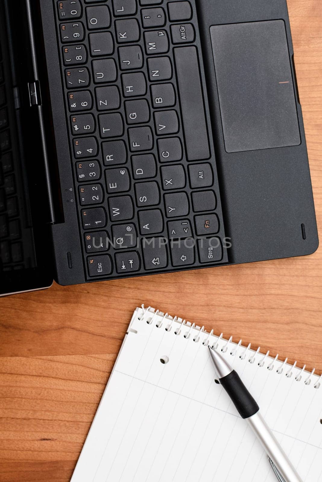 notebook and notepad with pen on wooden table from above
