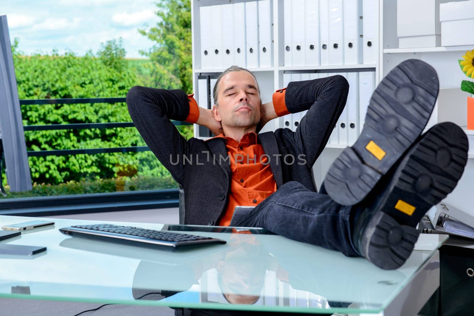 young business man at his desk is relaxing