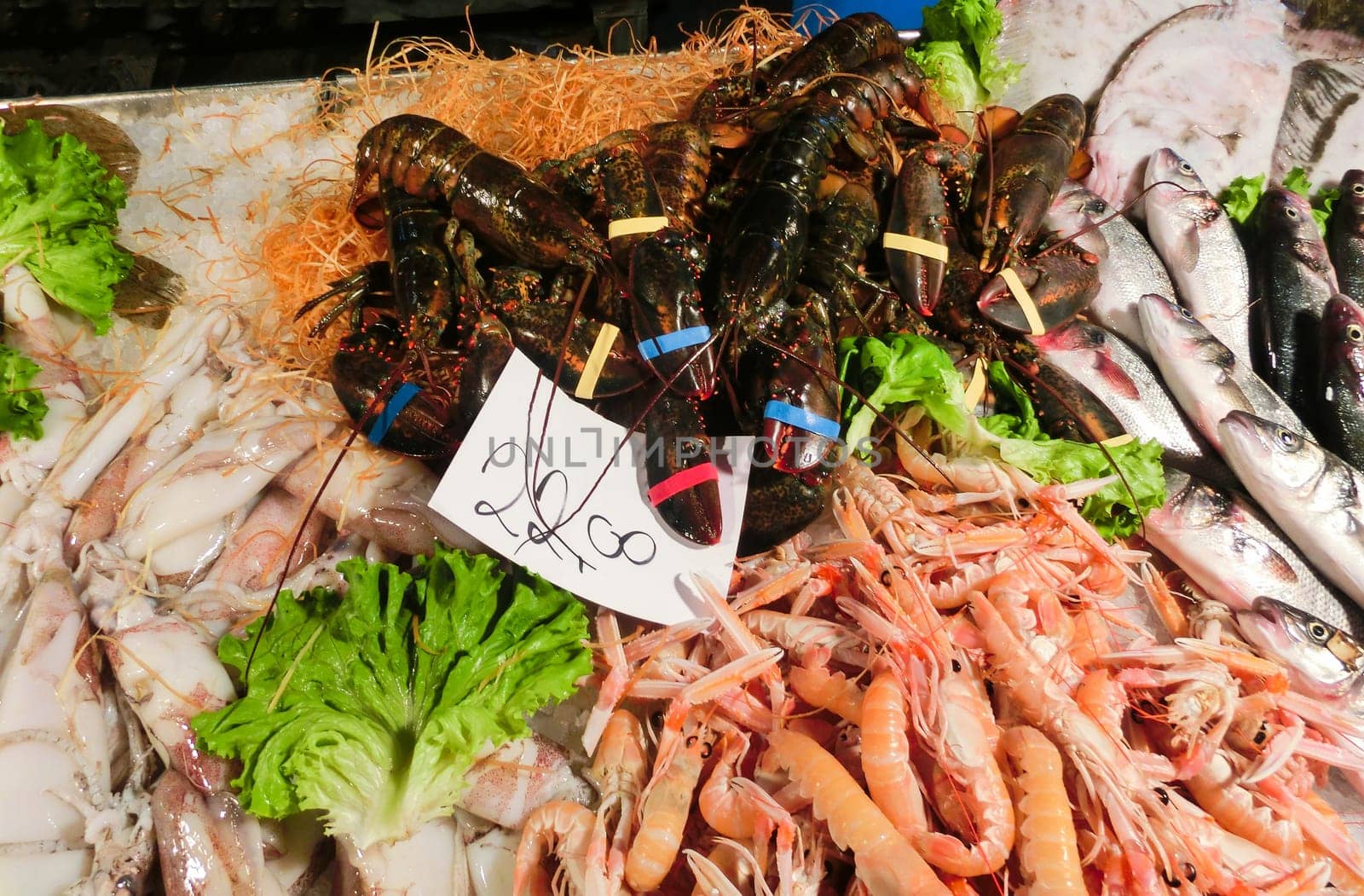 Venetian fish market - squids and lobsters and prawns. The Rialto fish market is located alongside the Grand Canal near the Rialto Bridge - Venice, Italy