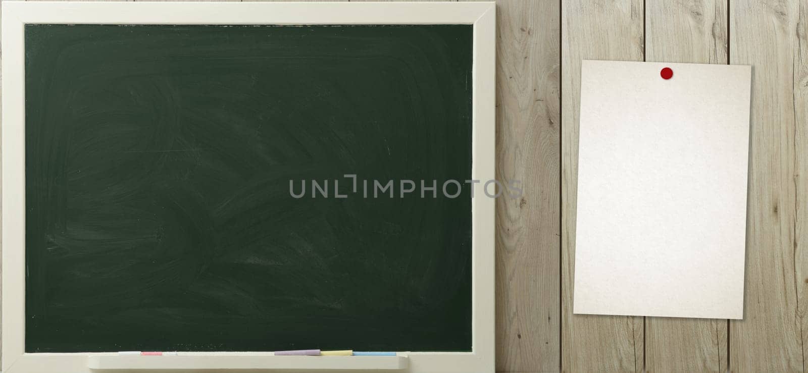 a blackboard and paper hanging on the wall