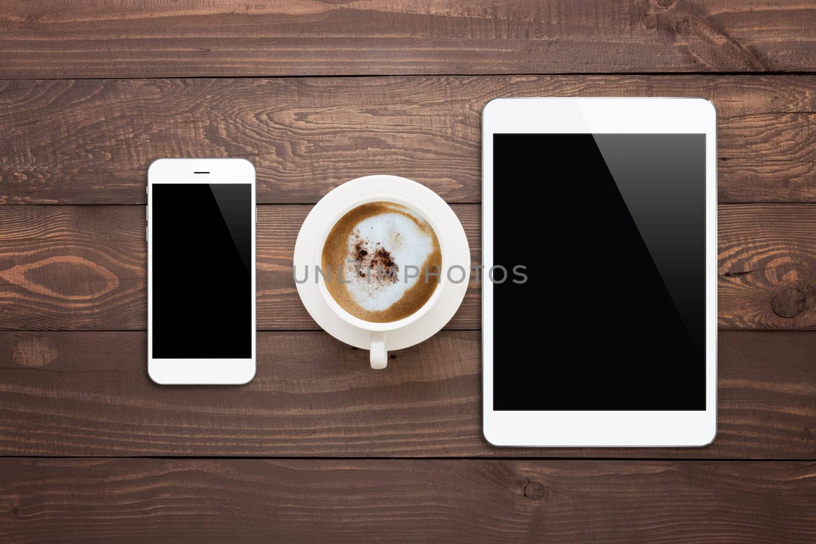 white phone tablet and coffee cup on wood table top view