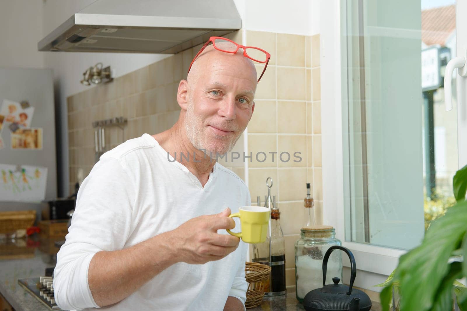 a mature man drinking a cup of coffee
