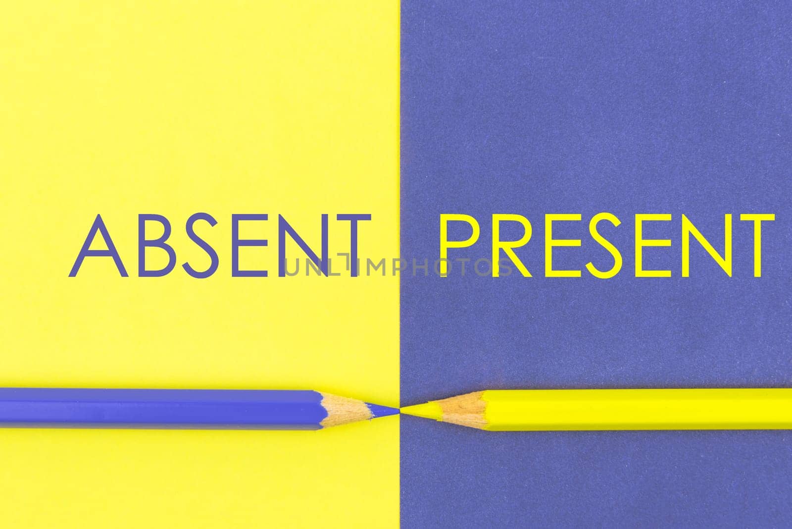 Absent versus Present contrast concept . Yellow and Violet coloured pencils and paper.