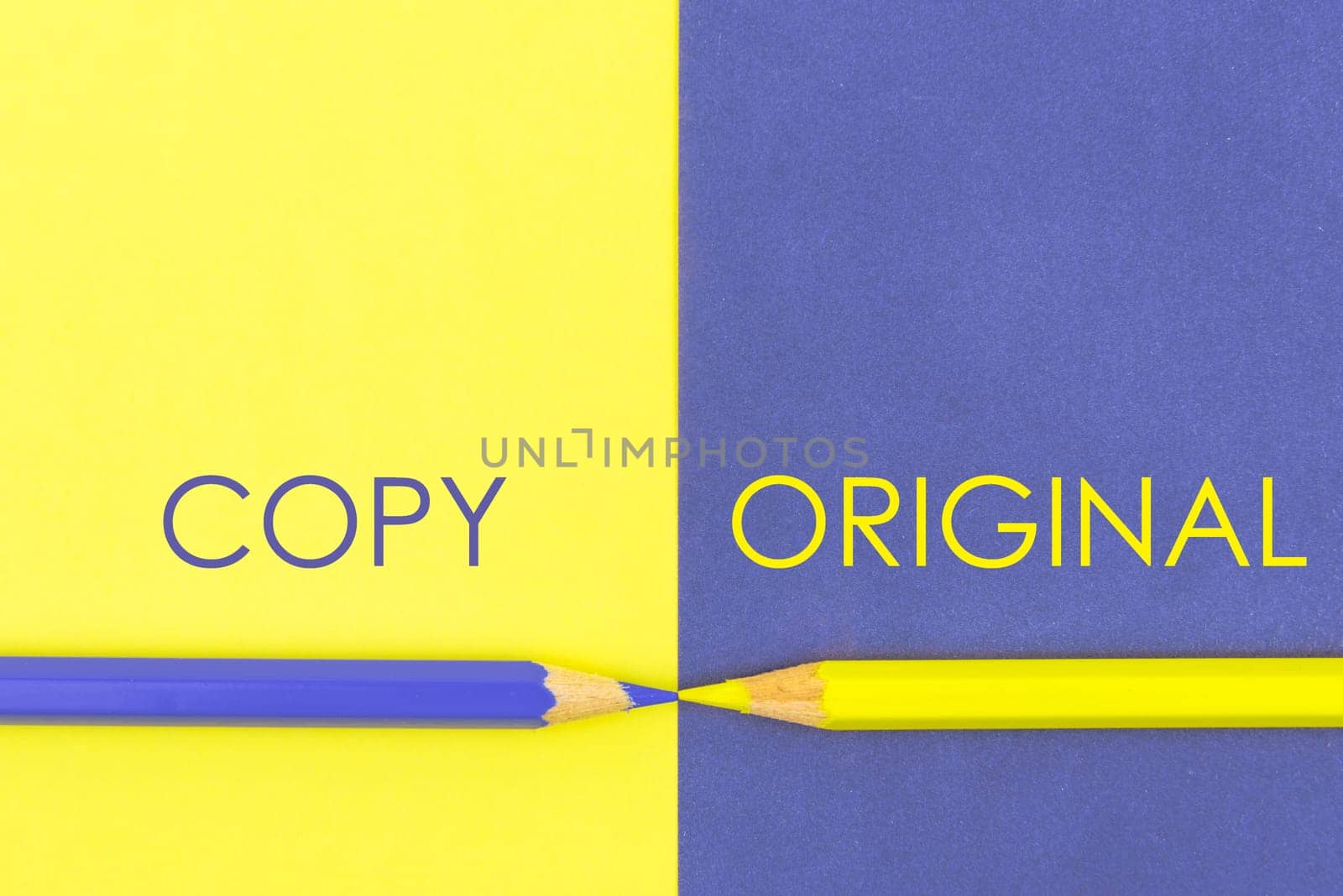Copy versus Original contrast concept . Yellow and Violet coloured pencils and paper.