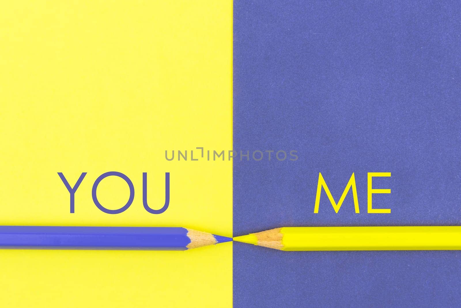 You versus Me contrast concept . Yellow and Violet coloured pencils and paper.