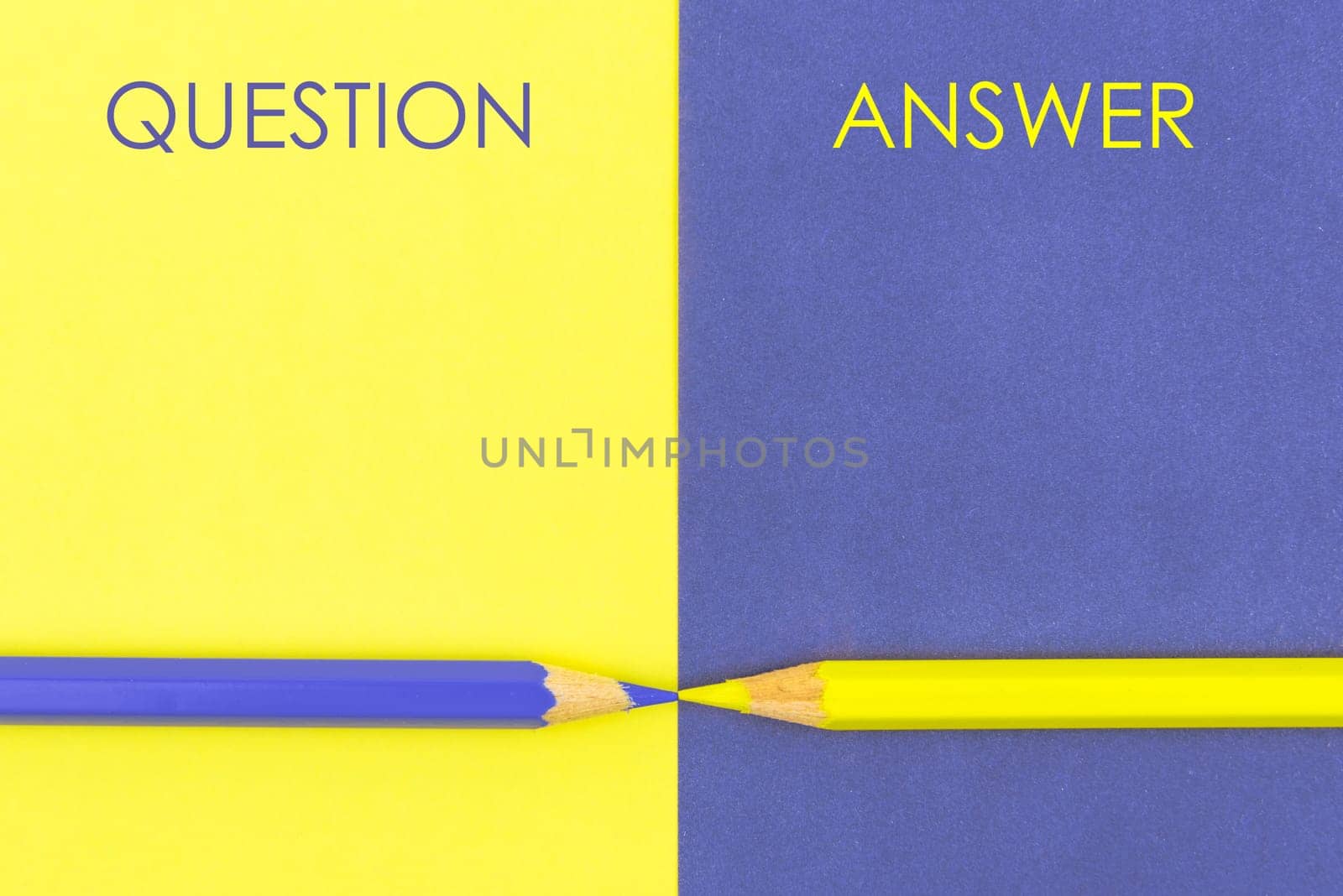 Question versus Answer contrast concept . Yellow and Violet coloured pencils and paper.