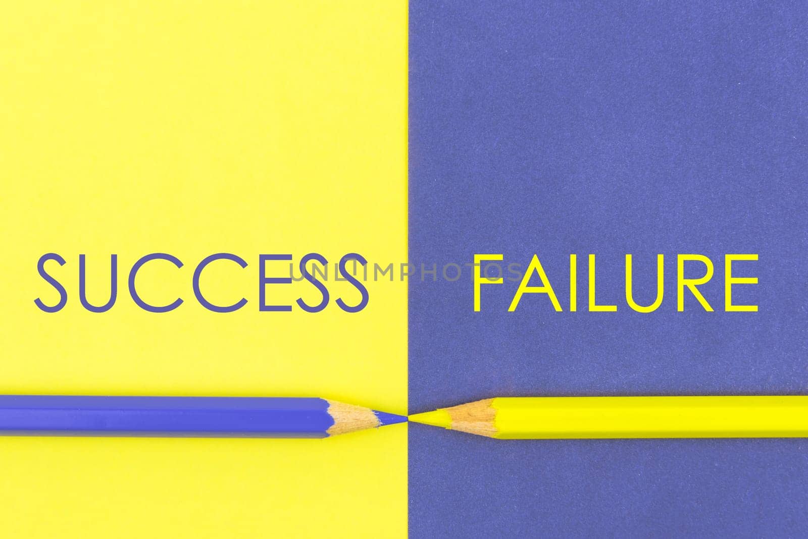 Success versus Failure contrast concept . Yellow and Violet coloured pencils and paper.
