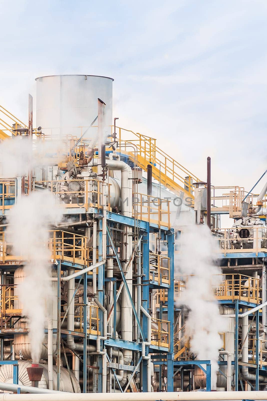 Chemical plant of a factory. Smokestacks ,pipes and tank.