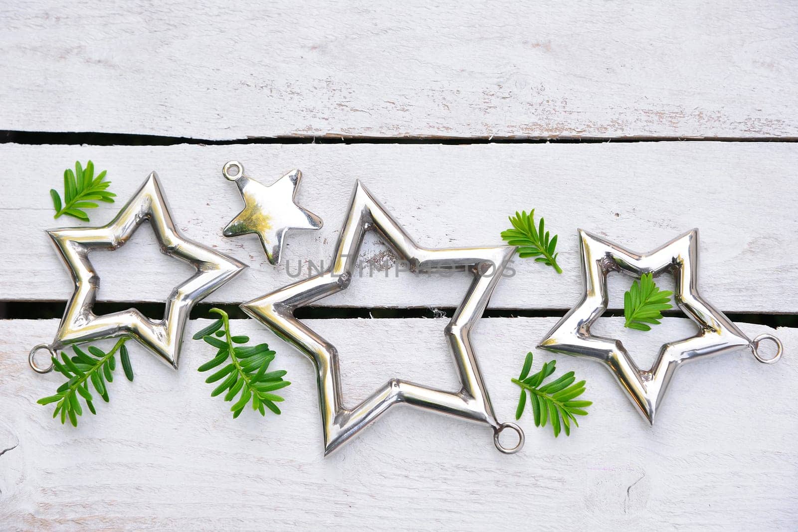 Christmas stars natural decoration on white wood background