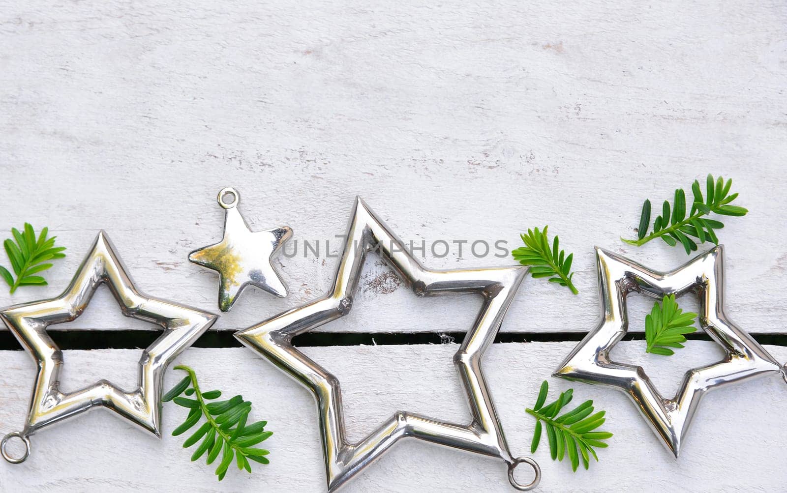 Christmas stars natural decoration on white wood background