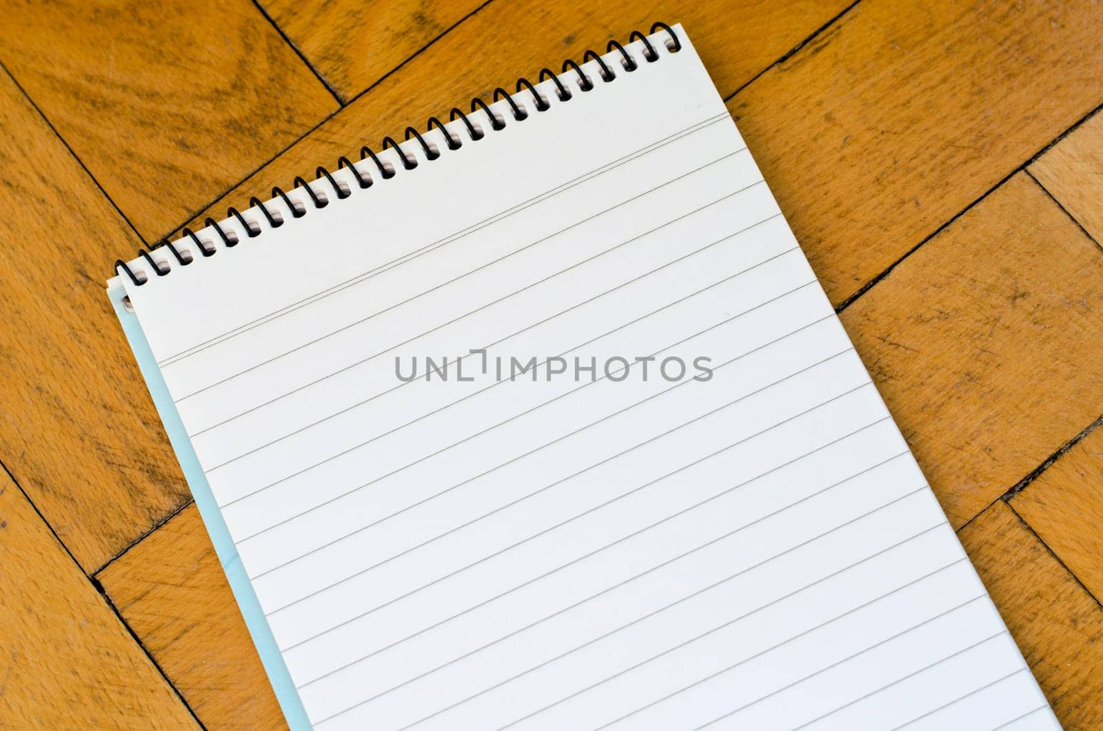 White notepad on the wooden background
