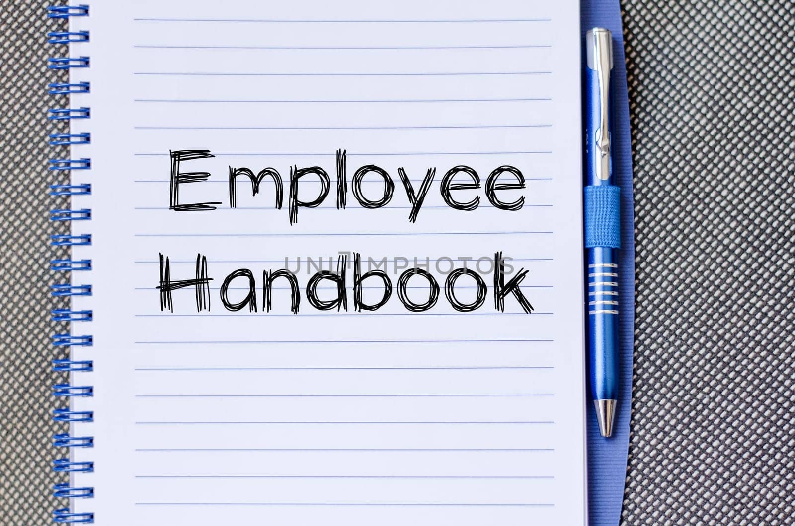 Employee handbook text concept write on notebook