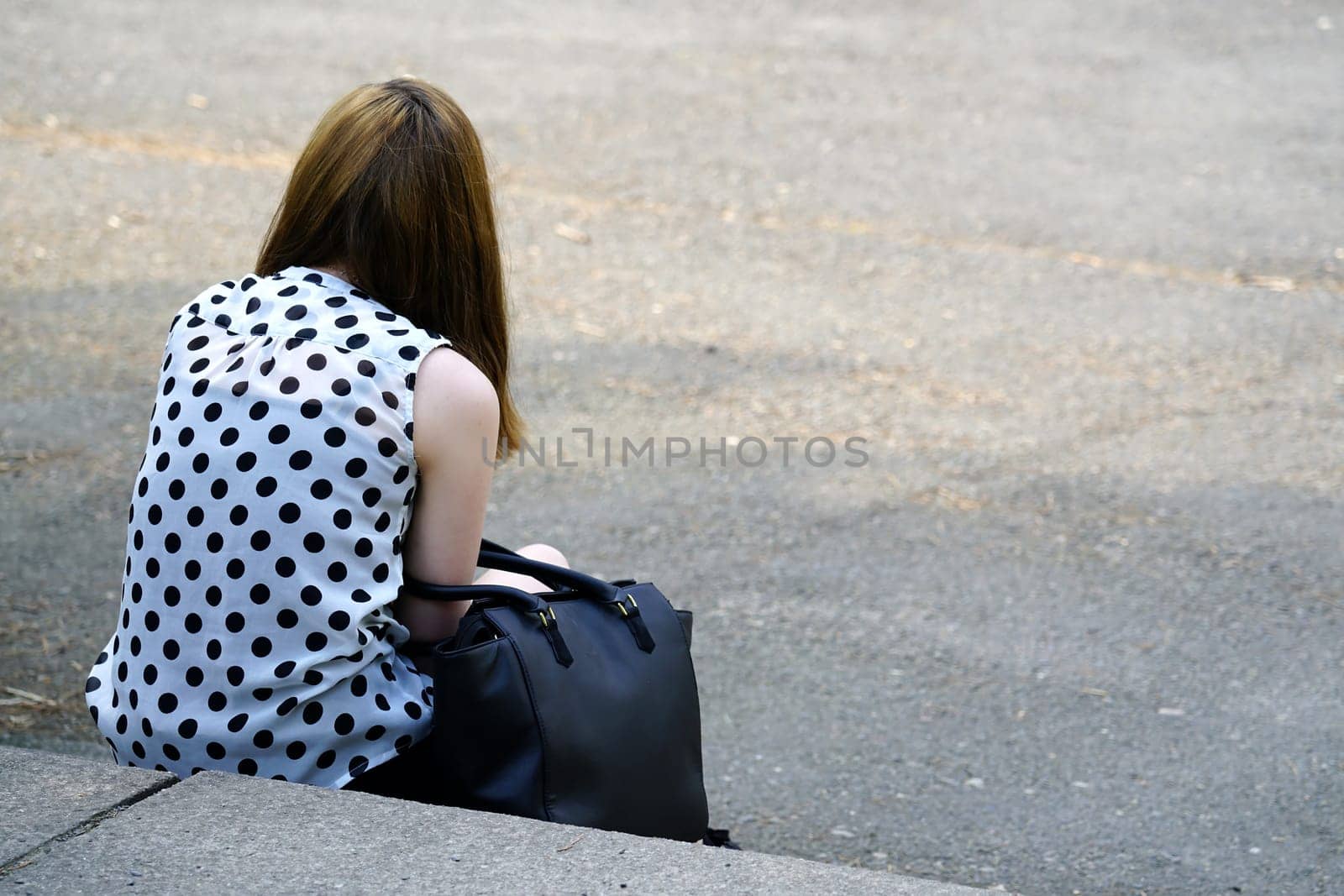 Teenager sits on a staircase
