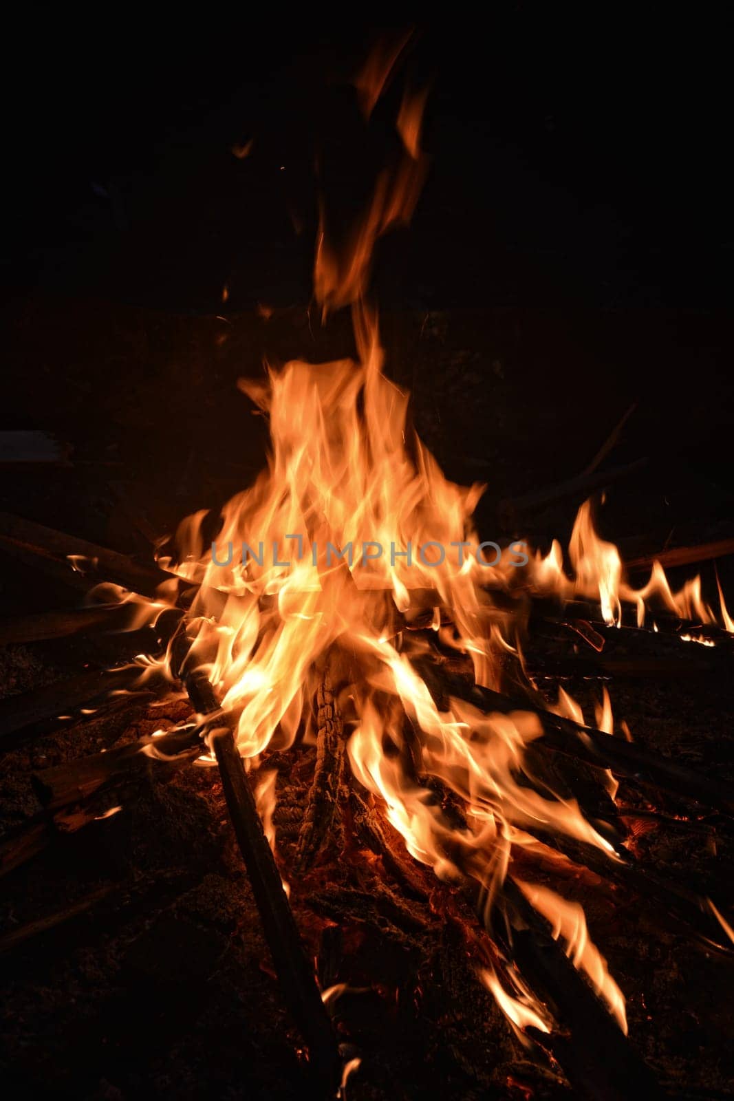 big wooden campfire at night