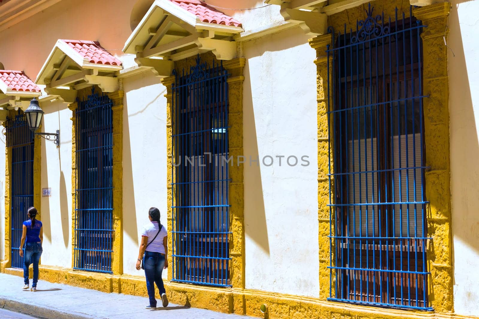 CARTAGENA, COLOMBA - MAY 23: People walk past old colonial buildings in Cartagena, Colombia on May 23, 2016