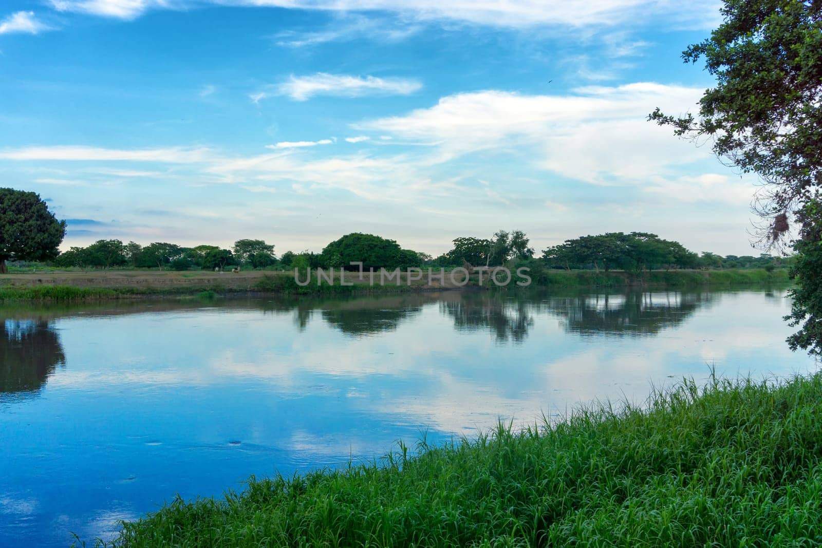 View of the Magdalena River with a beautiful reflection in Mompox, Colombia